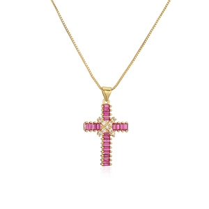 Macro shot of gold plated necklace featuring a pink zircon gemstone cross pendant