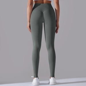 Detail view of seamless yoga pants featuring cross waist and peach butt lift design