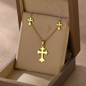 Golden cross necklace and earrings set presented in a premium beige velvet jewelry gift box