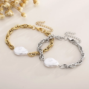Detail of baroque pearl on gold and silver stainless steel chain with lobster clasp