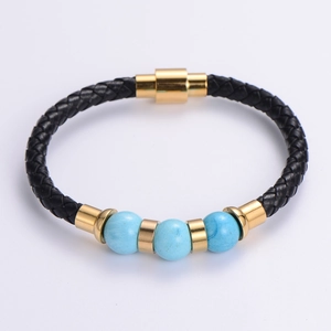 Detail of woven black leather bracelet with blue stones and gold magnetic buckle