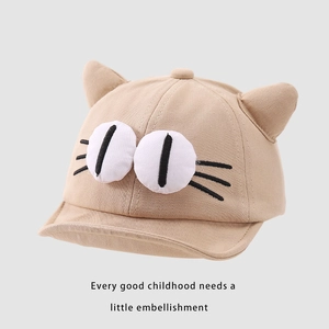 Detail of baby baseball cap with 3D cat ears and cartoon eye embroidery in khaki
