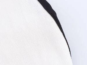 Close-up detail of contrast black trim stitching on white fabric V-neck dress