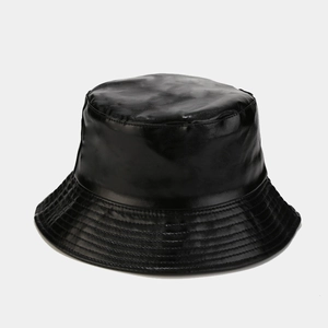 Detailed stitching and glossy finish on a black PU leather bucket hat with reinforced brim