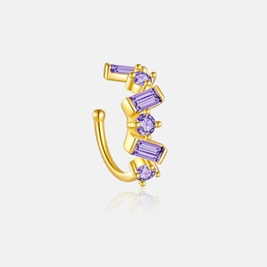 Detailed macro view of gold-plated C-shaped ear clip with purple zircon stones
