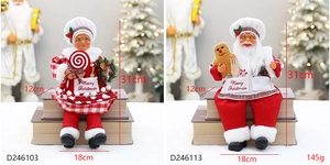 Detail of plush sitting Santa and Mrs. Claus figures with Merry Christmas aprons