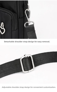 Detail of adjustable and detachable shoulder strap with silver heart zipper on black crossbody bag