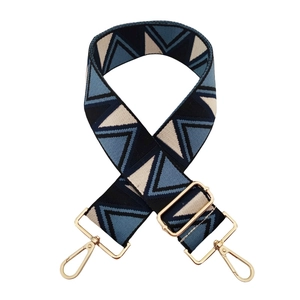 Detail of adjustable geometric triangle jacquard bag strap with gold metal hooks