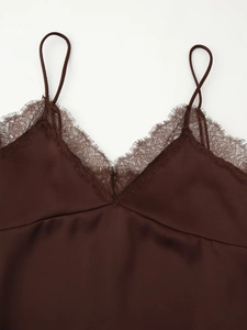 Detail of dark brown satin camisole featuring delicate eyelash lace trim on V-neckline