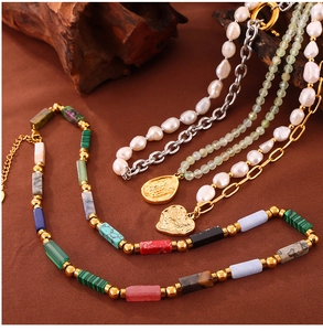 Detailed shot of multi-color natural stone and freshwater pearl necklaces with gold pendants