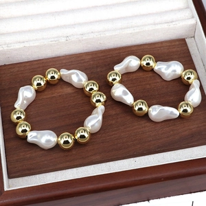 Detailed macro of baroque pearls and gold beads on an adjustable forest-style bracelet