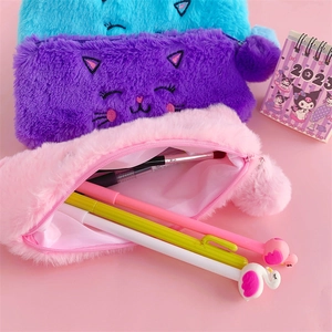 Detail of plush cat pencil cases in blue, purple and pink with soft embroidery