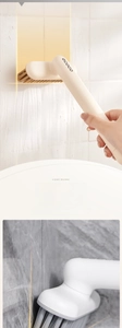 Detail of V-shape dense bristles cleaning tile gaps with ergonomic long handle