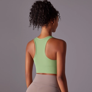 Close-up of light green racerback sports bra showing ergonomic back support and fabric detail