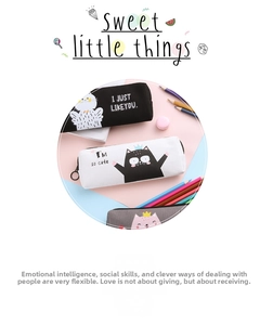 Detailed view of three canvas cat pencil cases with cartoon prints and zip rings