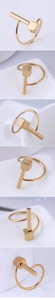 Detailed macro views of golden geometric ring with vertical bar and cube accents