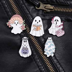 Close-up of five cute enamel ghost pins displayed on a black leather jacket with zippers
