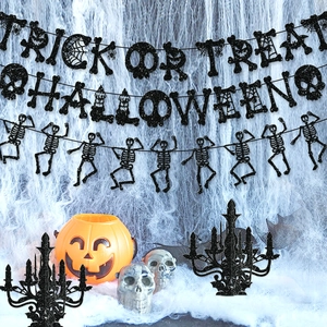 Glittering black Trick or Treat Halloween banner with pumpkin and skull party props