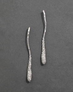 Detailed close-up of silver streamer wave earrings with micro-pave crystal diamonds