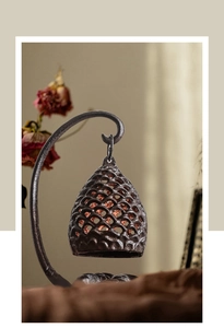 Détail d'une lanterne en fonte vintage avec motif grillagé sur un support élégant