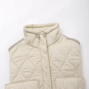 Quilted cream vest featuring high neck design and adjustable drawstring hem detail