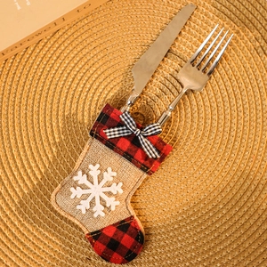 Detail of red and black plaid Christmas stocking cutlery holder with snowflake embroidery