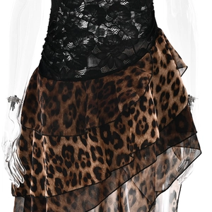 Detail of sheer black floral lace top paired with asymmetrical leopard print skirt layers
