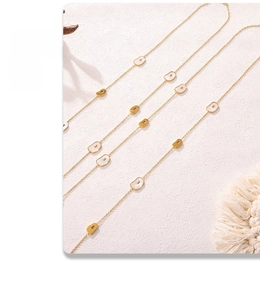 Macro detail of French natural shell pendant on a long gold-plated stainless steel chain