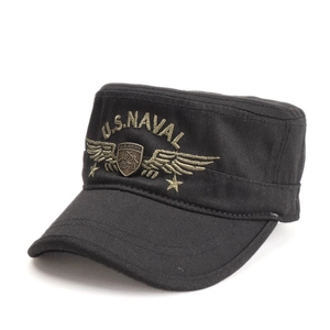 Detail of black military cadet cap with U.S. NAVAL embroidery and metal shield badge