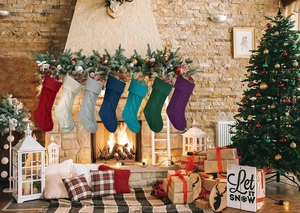 Cozy knit Christmas stockings in seven colors hanging by a festive fireplace