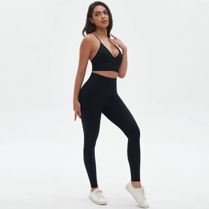 Full view of black seamless yoga set featuring a deep V-neck bra and high waist leggings