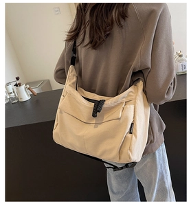 Model view showing the scale and drape of this beige canvas crossbody tote bag