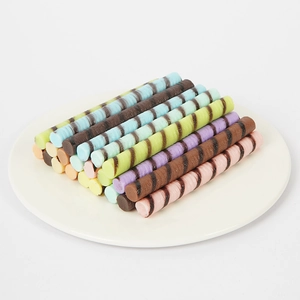 Realistic PVC chocolate wafer rolls in macaron colors displayed on a white plate