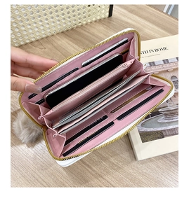 Detail of white PU leather wallet with pink interior showing card slots and phone pocket