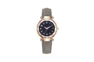 Detail of rose gold watch with blue starry sky dial and gray leather strap