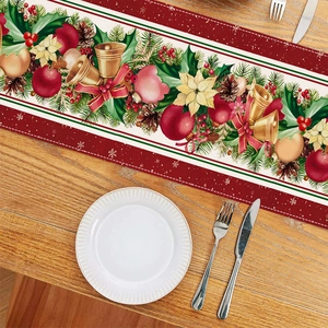 Detailed pattern of a Christmas table runner with bells and pine needles on a wood table