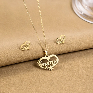 Close-up of golden hollow heart necklace and mama earrings with floral details