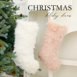 Plush Christmas stockings in white and pink hanging on a festive decorated tree