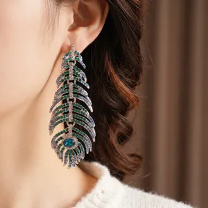 Vintage silver feather earrings with emerald and blue rhinestones for a luxury retro look