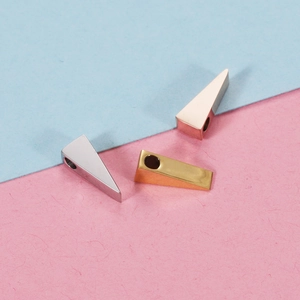 Macro view of 3x10mm triangular stainless steel beads in silver, gold, and rose gold