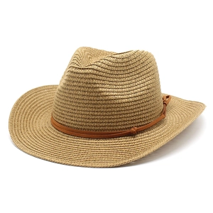 Detail of straw cowboy hat with a brown leather band and intricate hand-woven texture