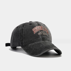 Detail view of the Brooklyn 1898 embroidery on a washed dark gray denim baseball cap