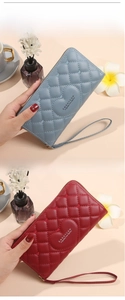 Detail of long PU leather wallets with heart quilting, wrist strap and zipper closure