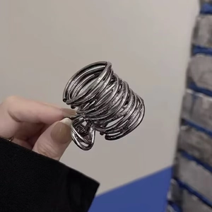 Close-up of gunmetal alloy hair claw with twisted metal wire design for high ponytails