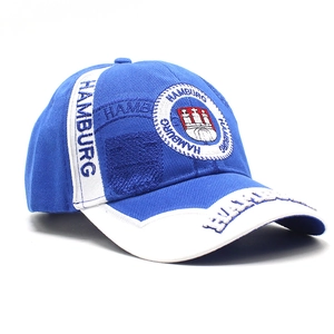 Detail of embroidered Hamburg crest and text on blue and white cotton baseball cap