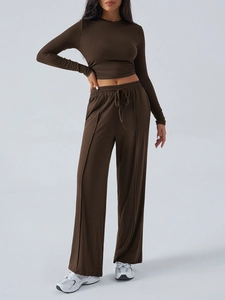 Detail view of brown long sleeve crop top and high-waist wide leg pants with drawstring