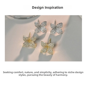 Detailed macro view of butterfly stud earrings with gold and silver micro-set zircon crystals