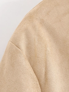 Detailed macro view of camel faux suede jacket fabric showing soft brushed texture