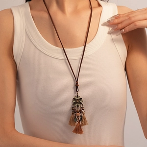 Vintage bohemian long necklace with bronze flower, wooden beads, and velvet tassels