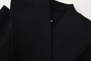 Close-up of the notched lapel and shoulder tailoring on this black slim fit blazer